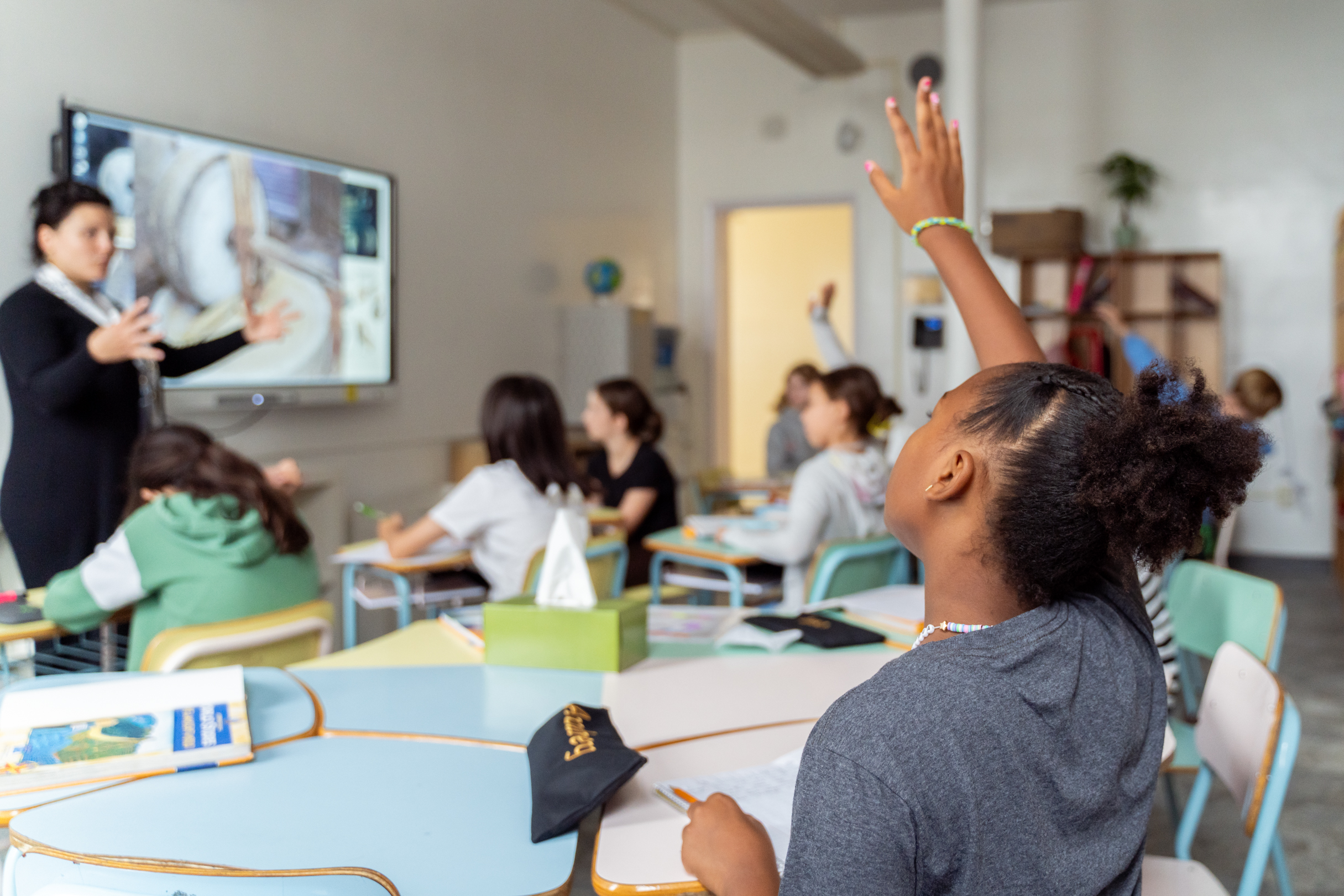 Engaged students in classroom with teacher
